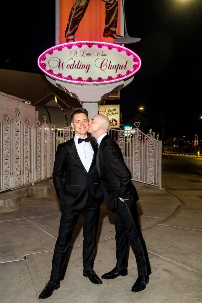 groom kissing the groom on the cheek