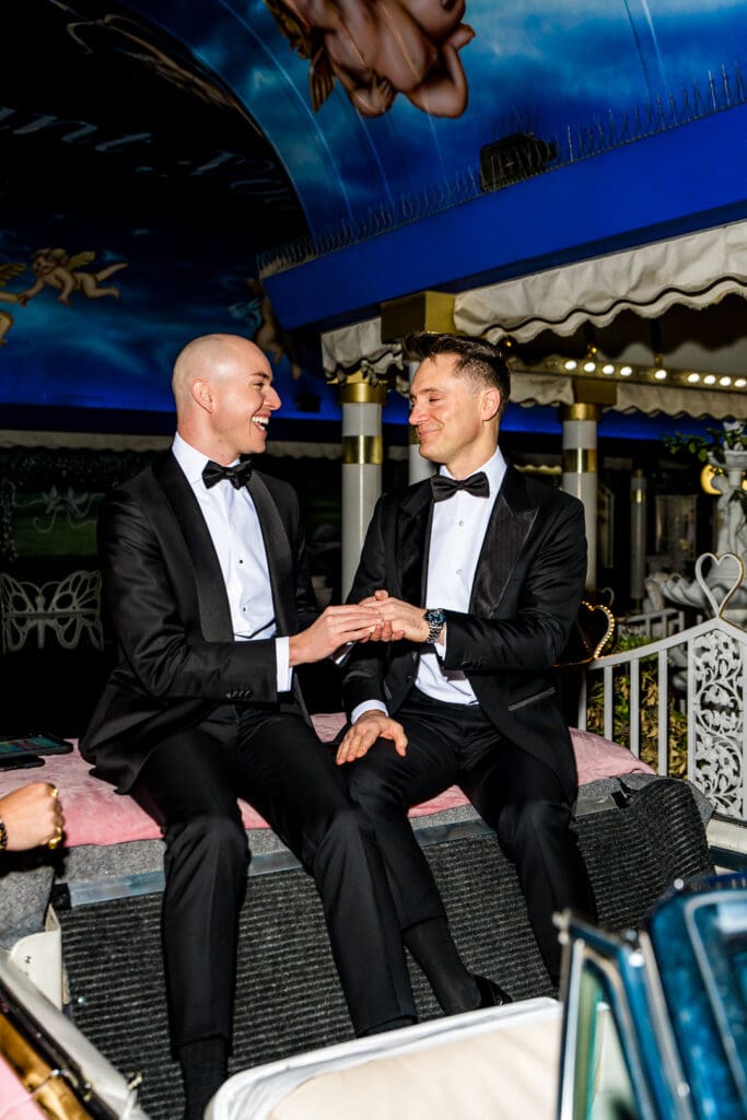 grooms laughing with each other during their ceremony