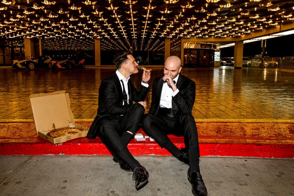 couple having fun and eating pizza at their las vegas elopement
