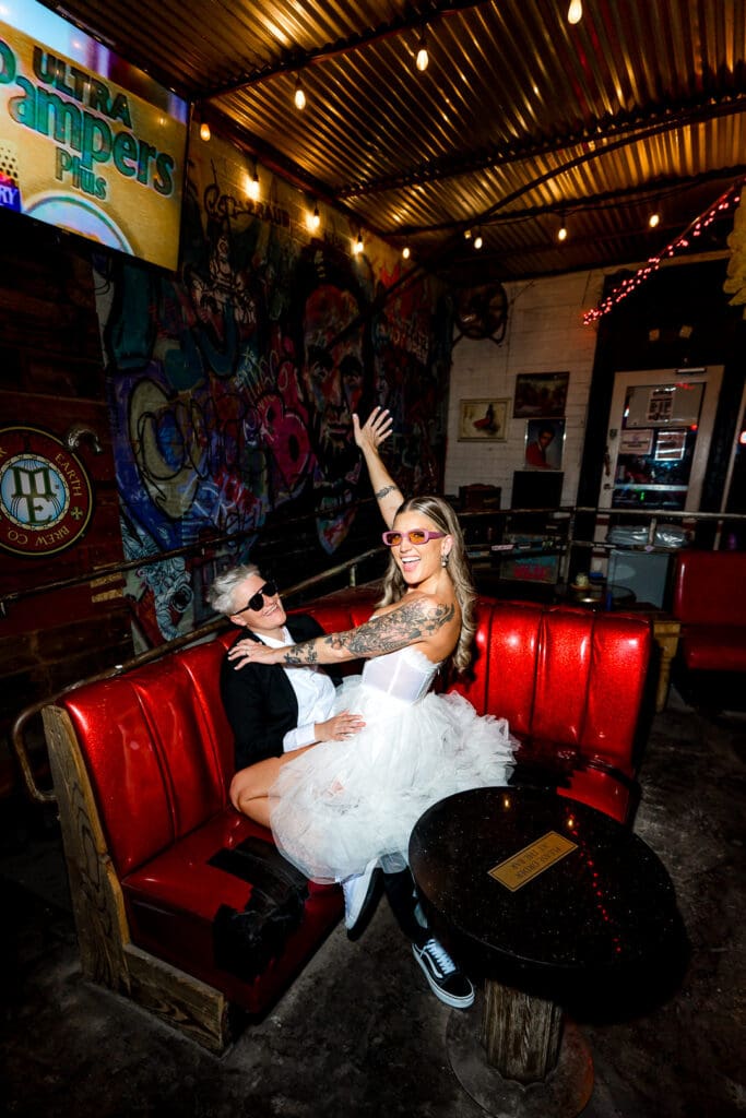 couple celebrating their dream elopement with drinks