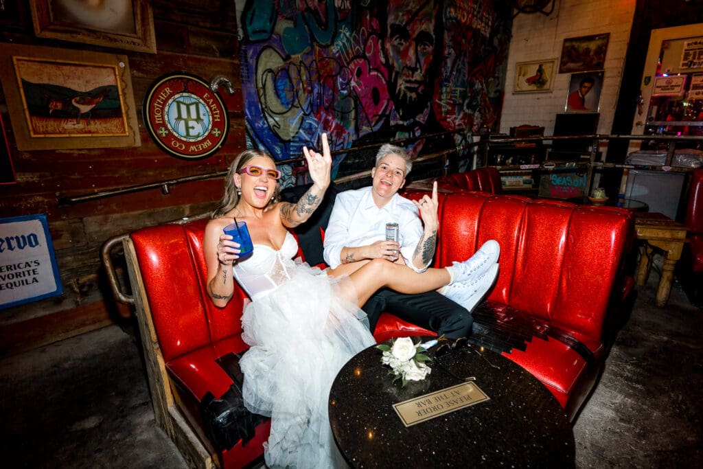 playful portrait of the newlyweds at a bar