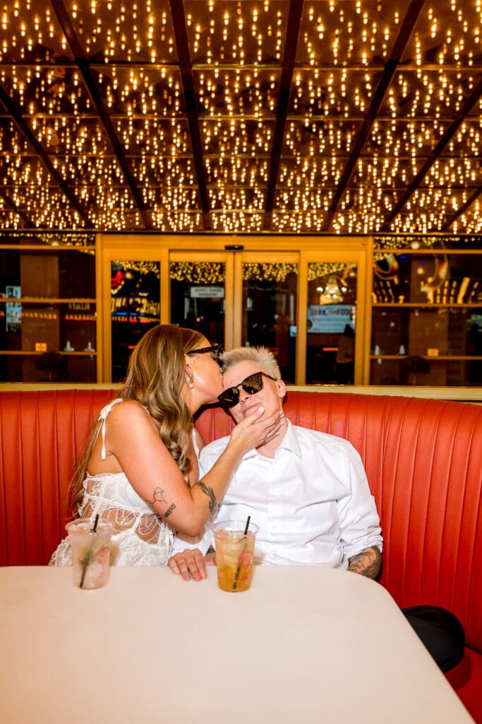 cute couple at their favorite bar having a drink after their elopement  
