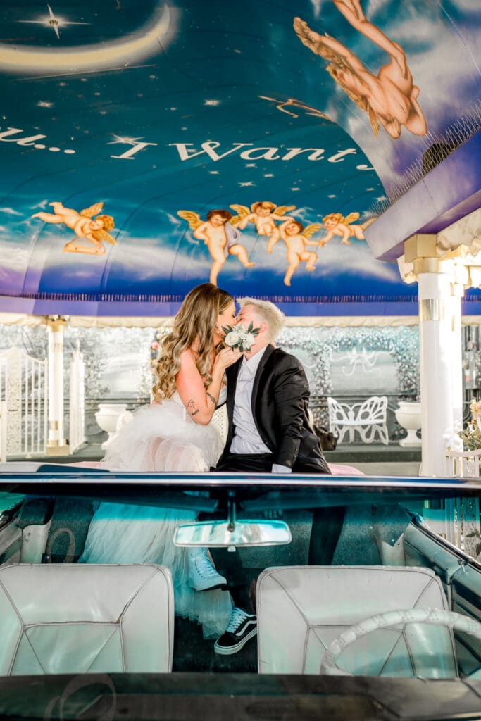 brides kissing during their electric las vegas elopement