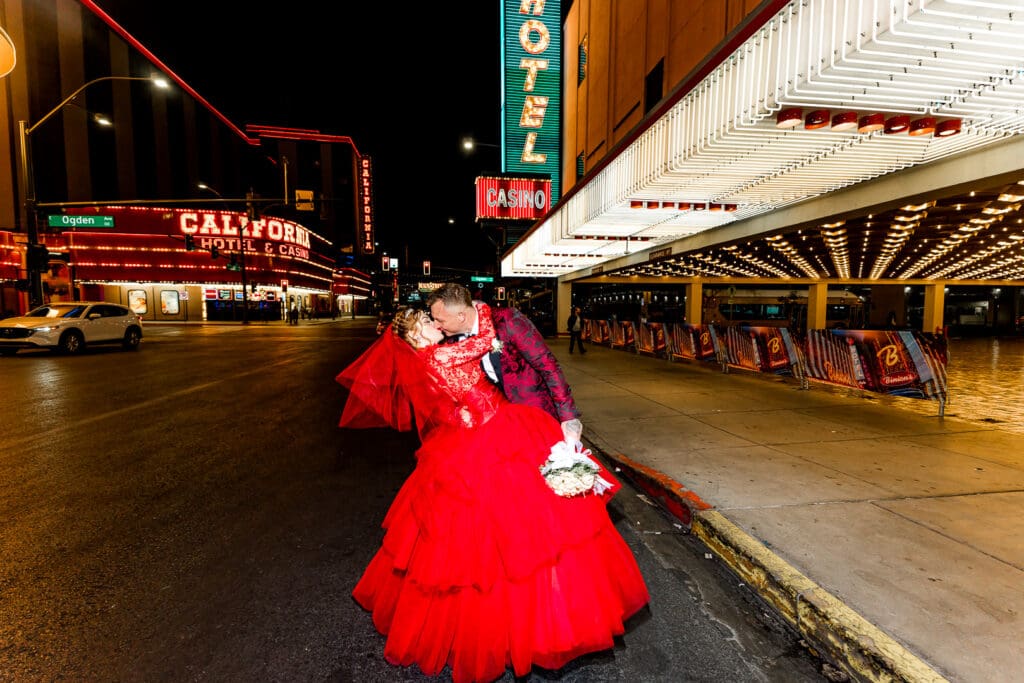 portrait of the newlyweds kissing at fremont street