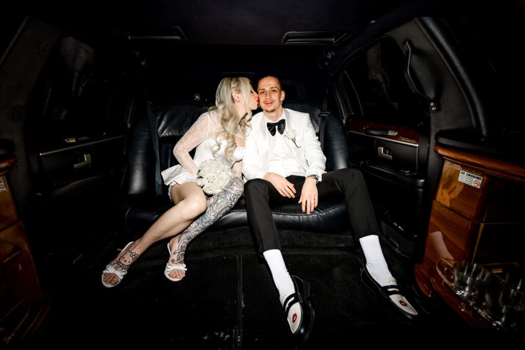 bride kissing the groom on the cheek at their iconic las vegas elopement
