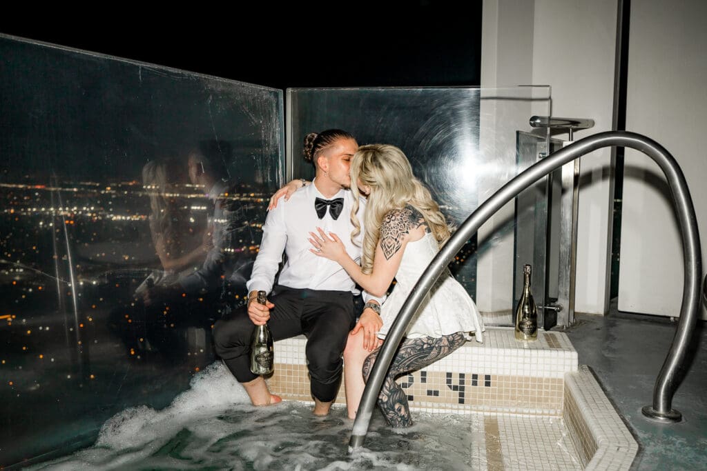 bride and groom kissing in the jacuzzi