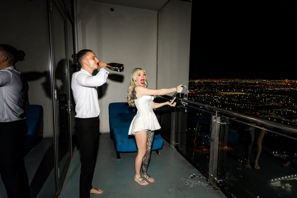 happy newly married couple drinking champagne at their iconic las vegas elopement