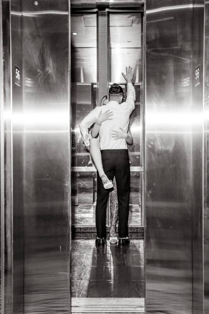 couple kissing in the elevator during their photoshoot