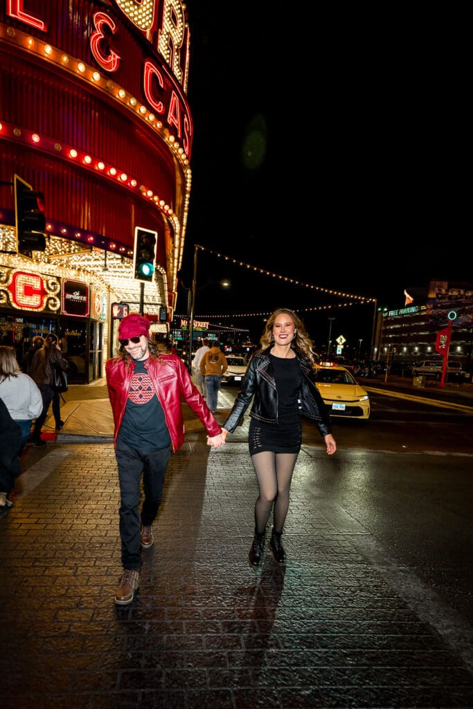 cute couple walking around fremont street during their photoshoot 