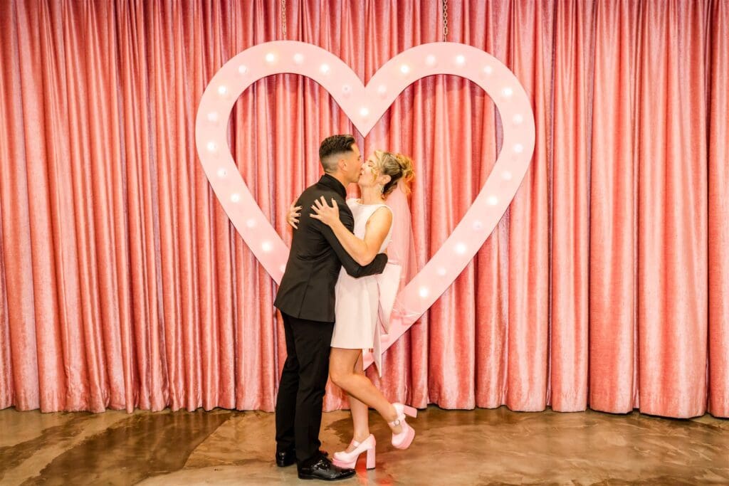 cute picture of the bride and groom kissing after their ceremony