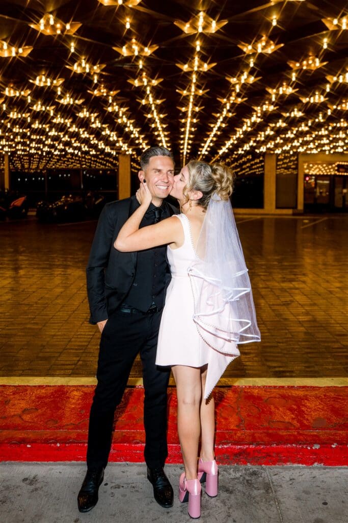 bride kissing the groom on the cheek
