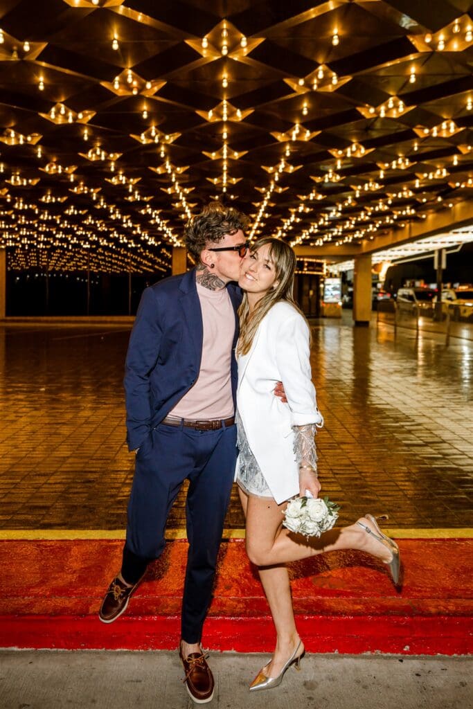 groom kissing the bride on the cheek