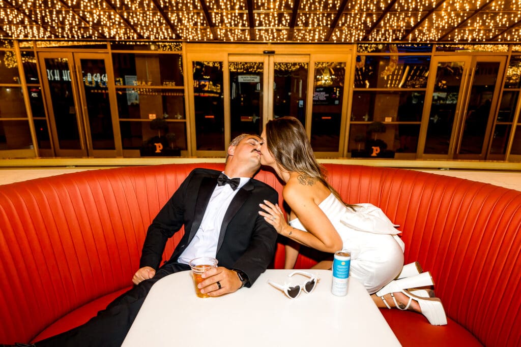 picture of the groom kissing the bride on the neck