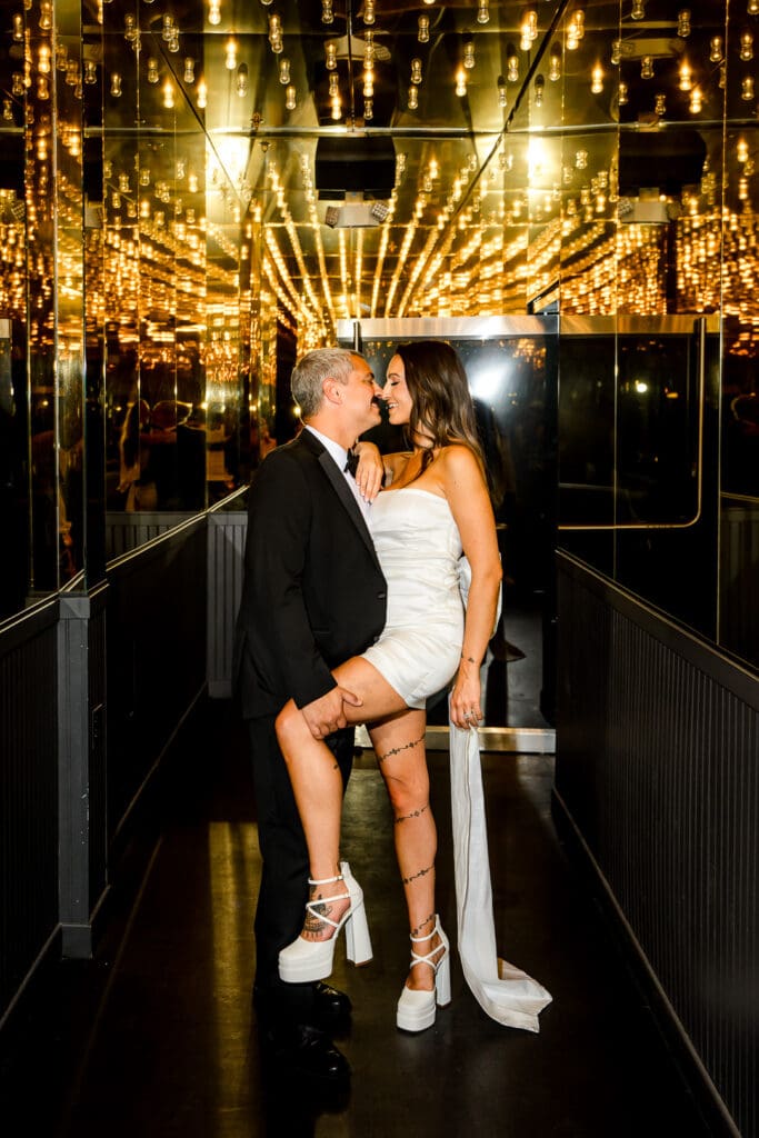 picture of the newlyweds kissing at their favorite bar in vegas 