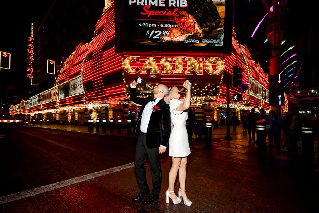 newly married couple drinking champagne in fremont street