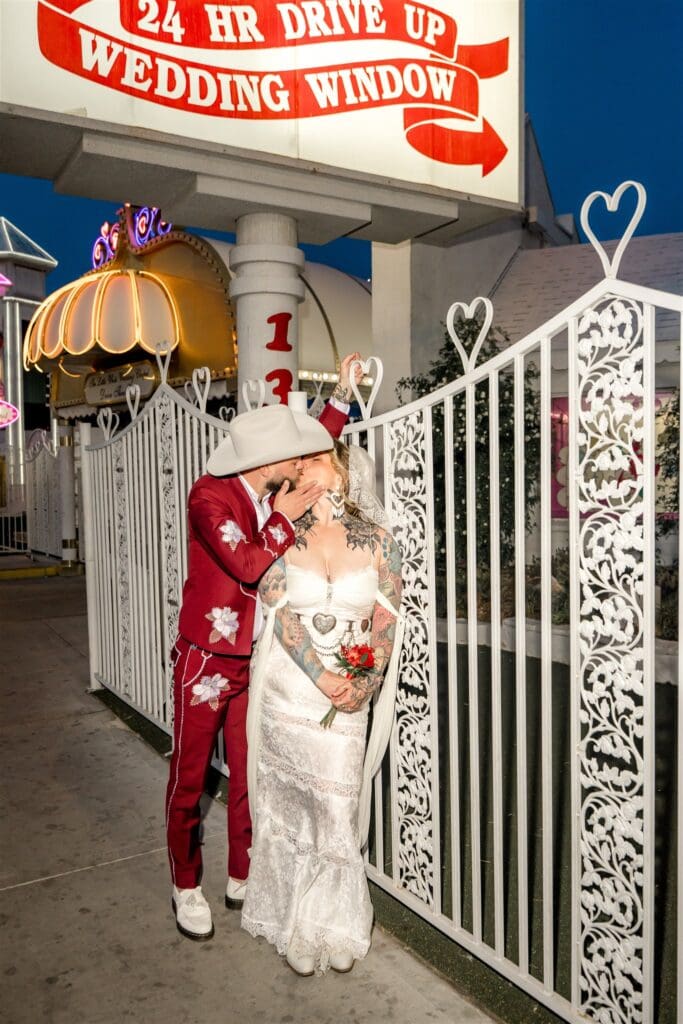 portrait of the newlyweds kissing outside the chapel