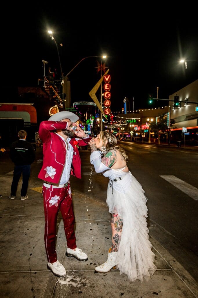 couple shotgunning a beer during their bridal portraits