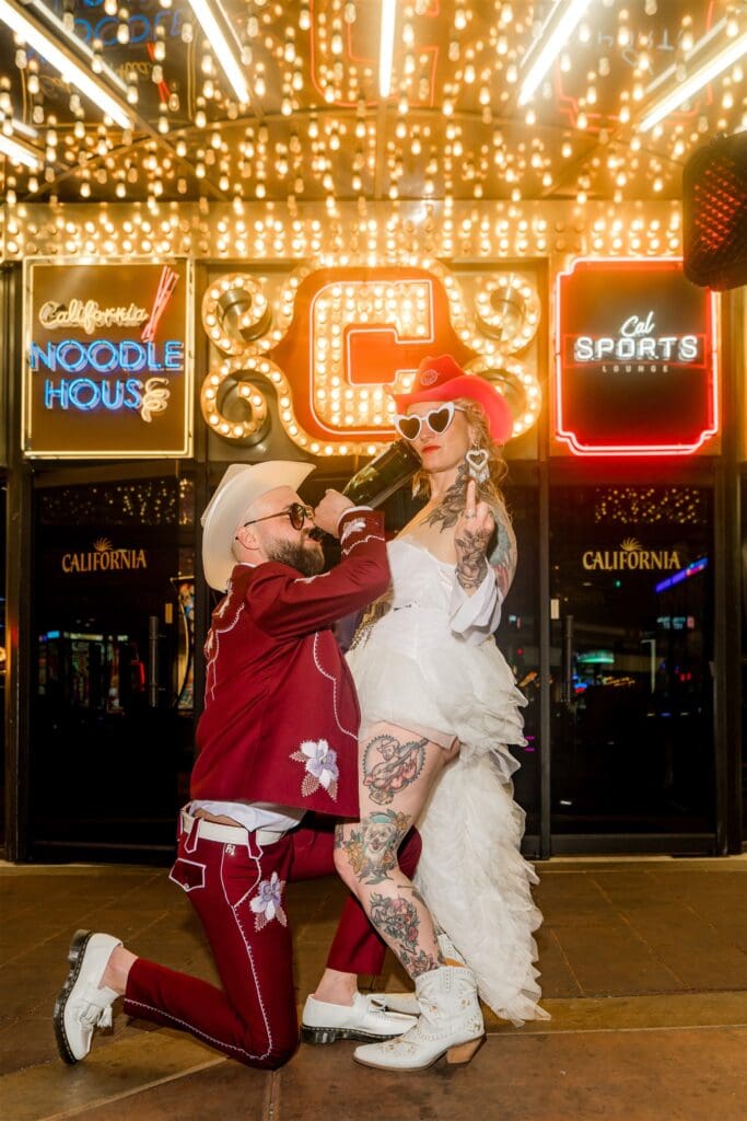 couple celebrating their elopement with a bottle of champagne