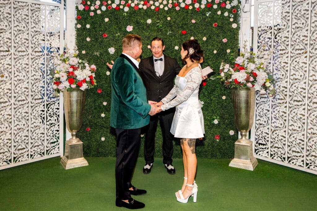 bride and groom holding hands at their dream elopement in sin city