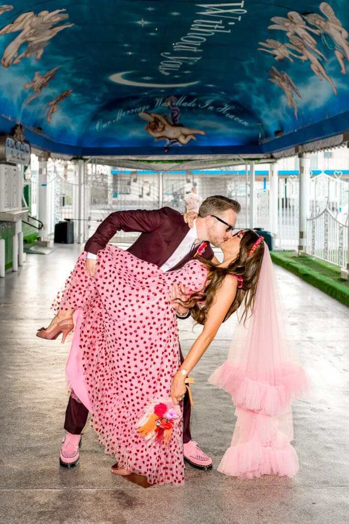 portrait of the couple kissing at little white wedding chapel