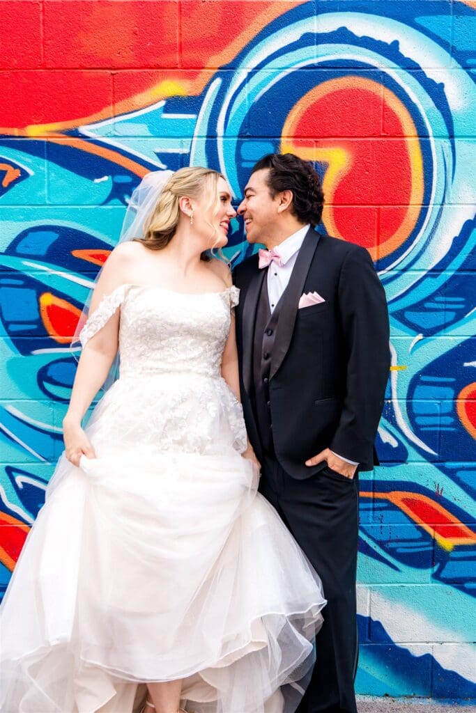 bride and groom smiling at each other during their session