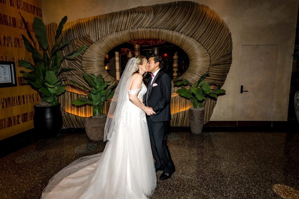 picture of the bride and groom kissing after their first look