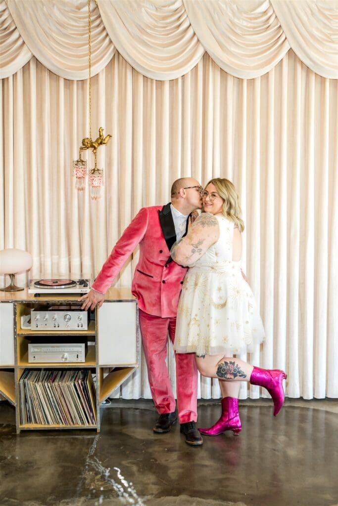 groom kissing the bride on the cheek