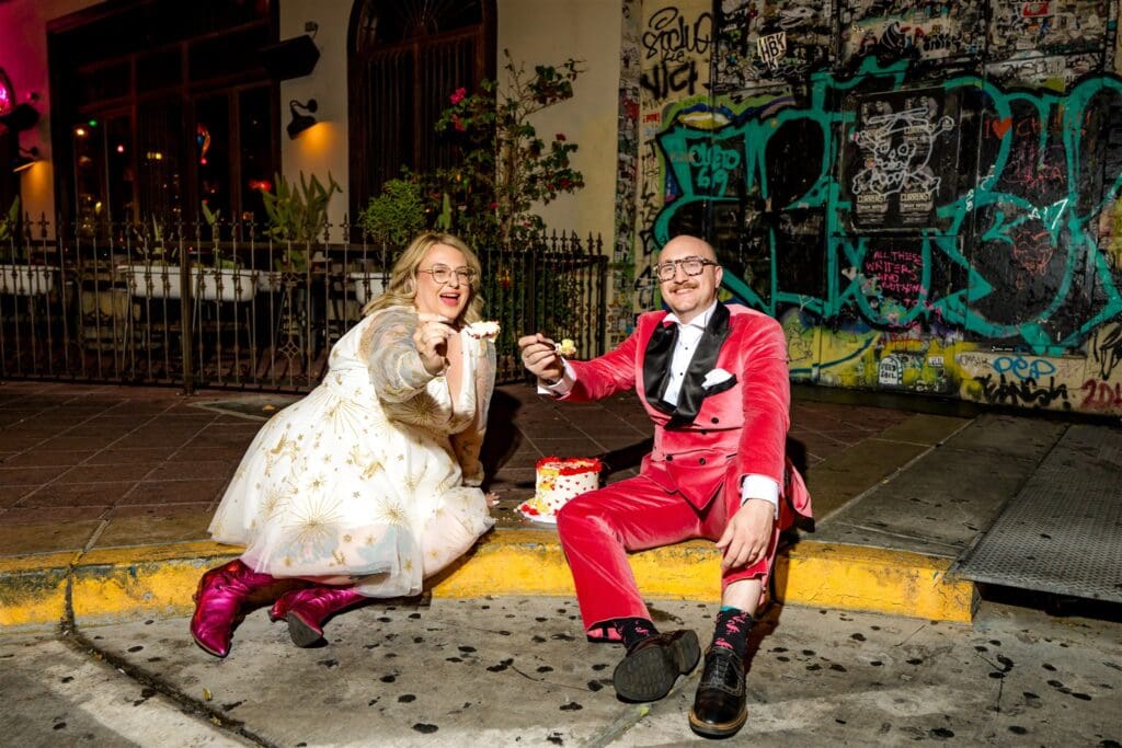 happy couple enjoying their wedding cake