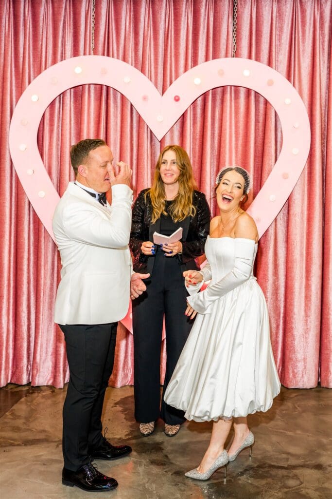 bride and groom laughing during their ceremony in sin city