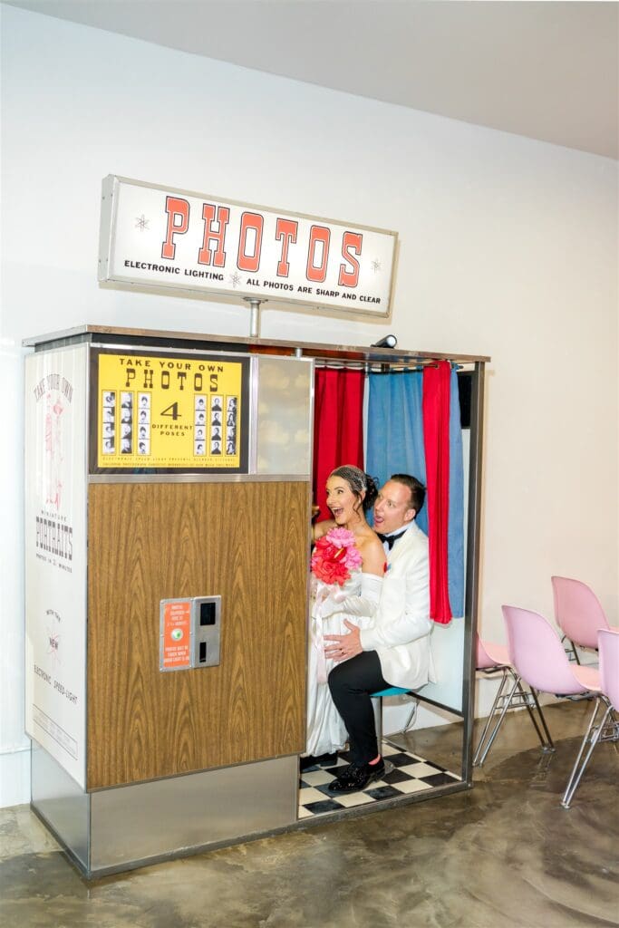 couple at a photo booth after their ceremony