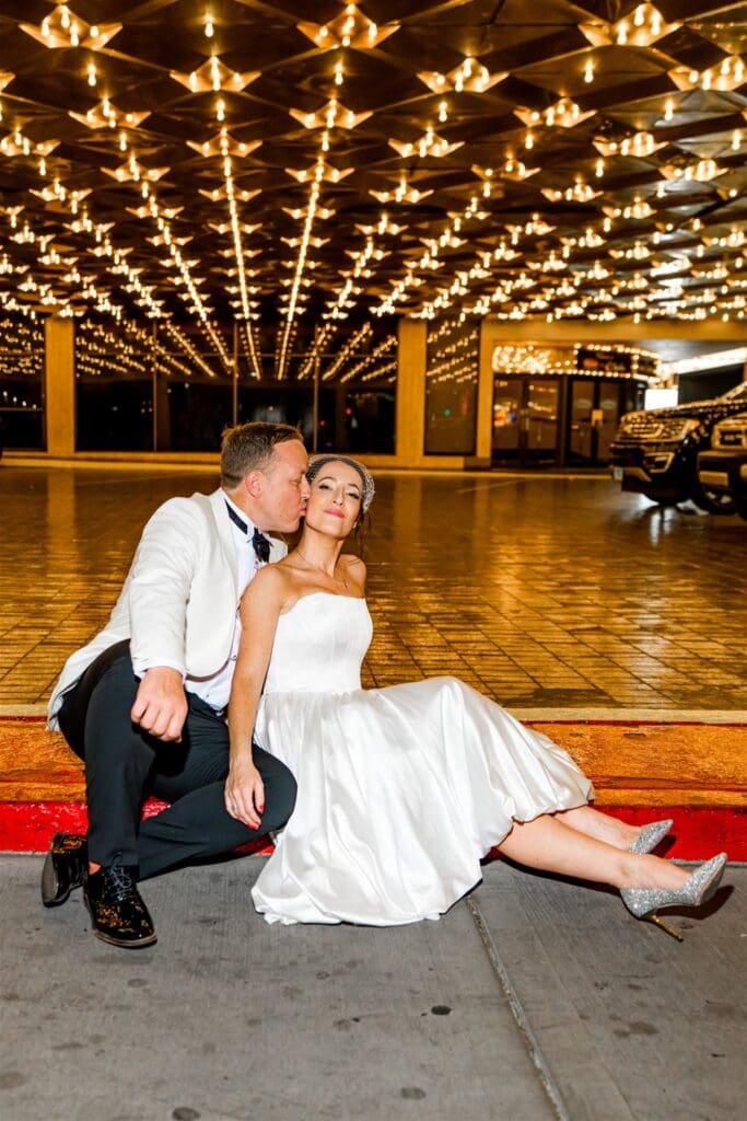 groom kissing the bride on the cheek