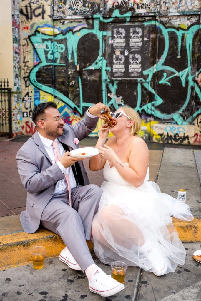 couple having pizza after their elopement 
