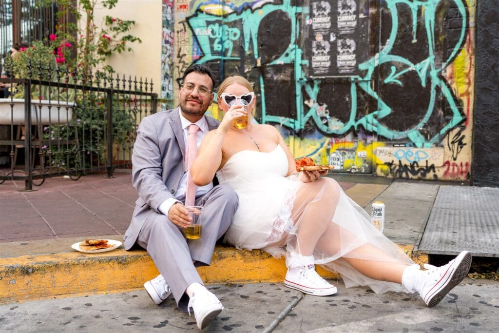 couple celebrating their elopement with beer