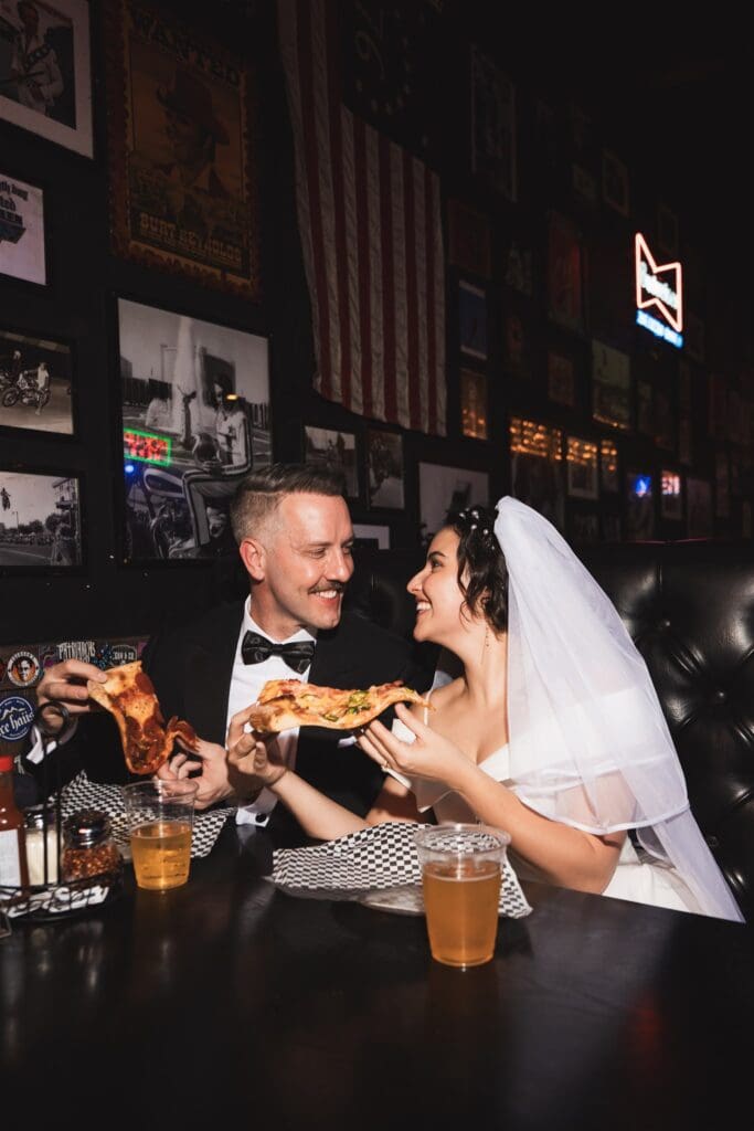 happy couple celebrating their elopement with pizza