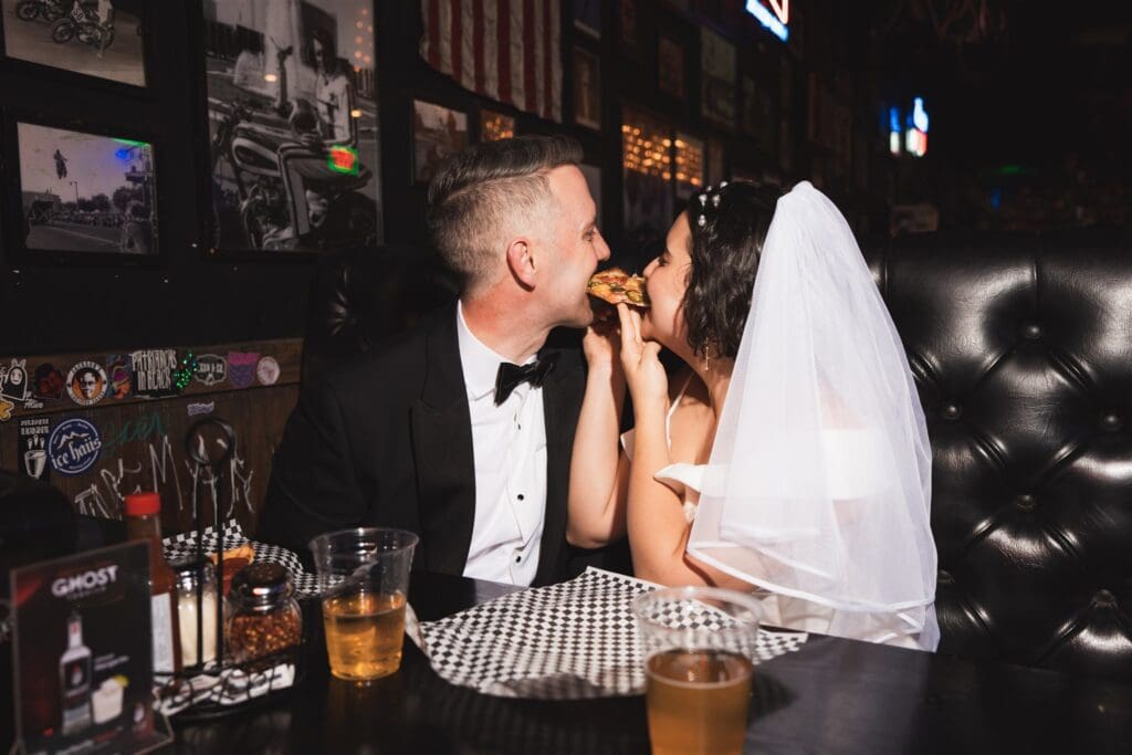couple having pizza after their elopement cermeony