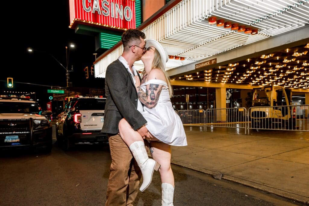 portrait of the newlyweds kissing in downtown fremont street