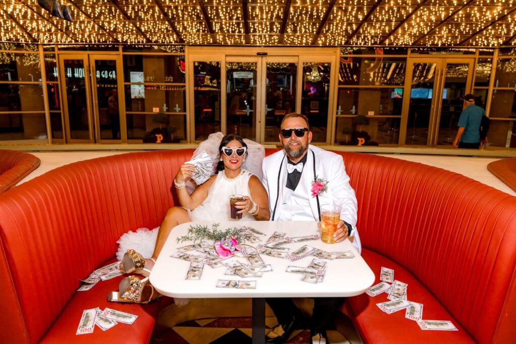 happy couple celebrating their elopement with a drink