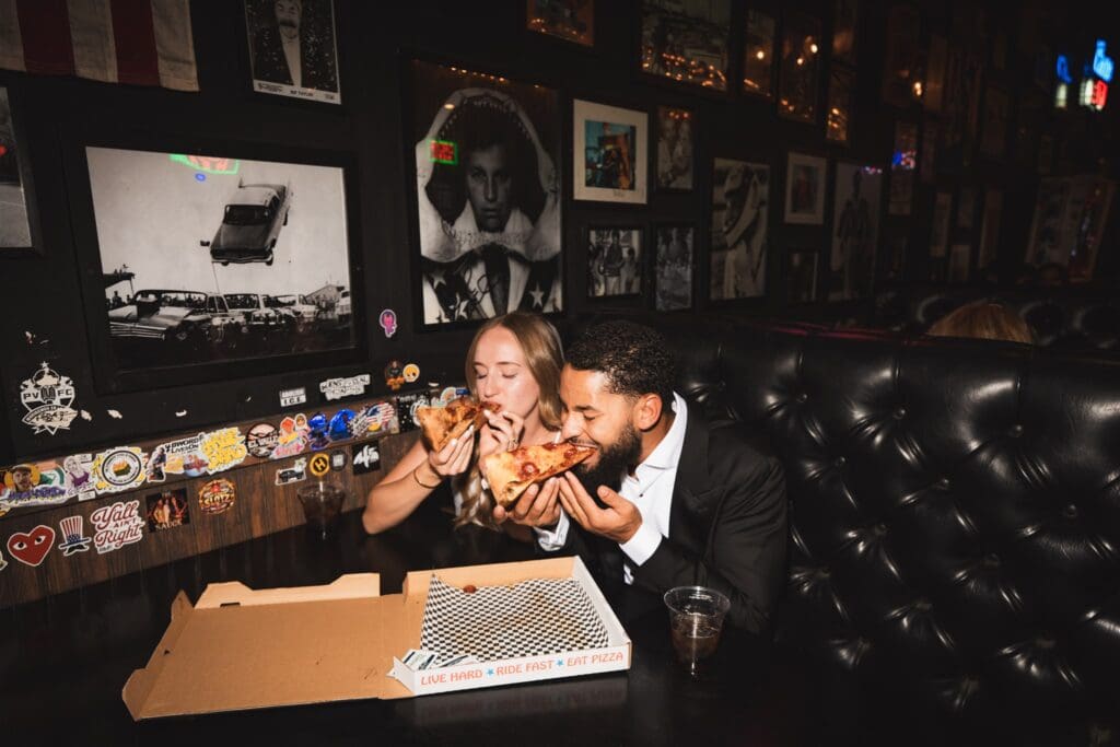 Couple celebrating their elopement with pizza