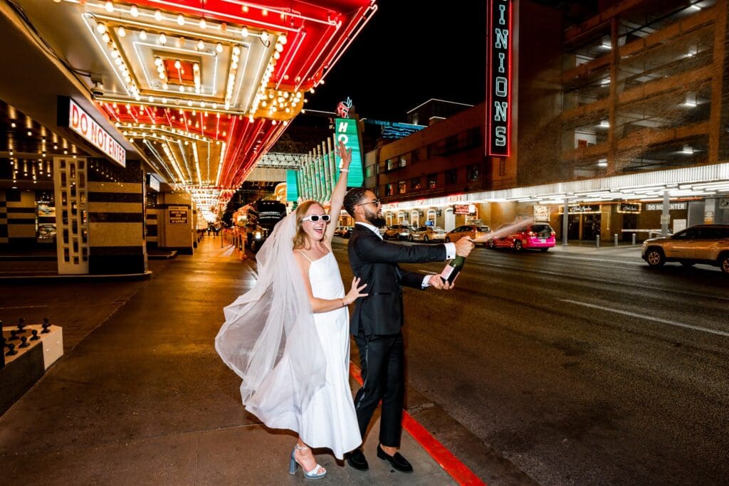 Newly married couple celebrating their elopement with champagne