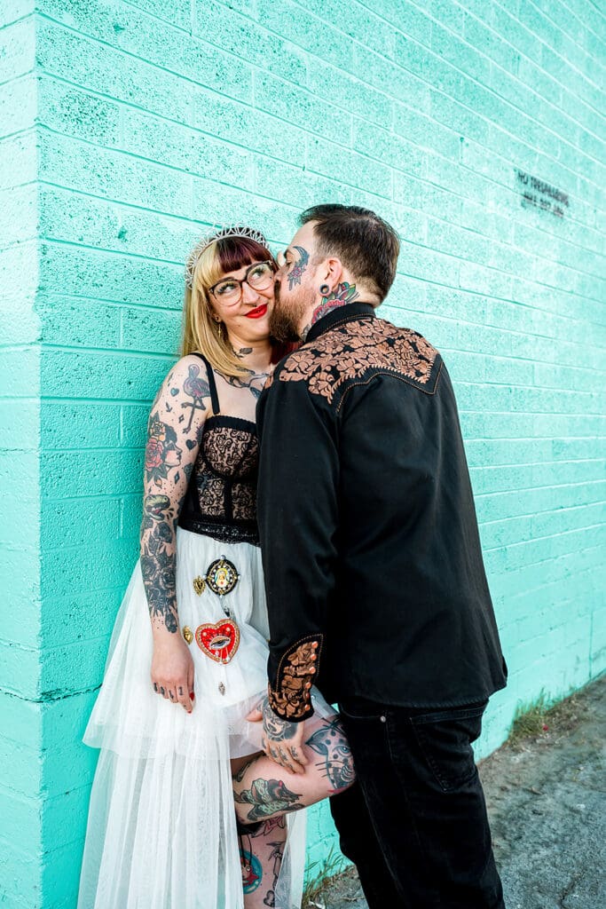 groom kissing the bride on the cheek