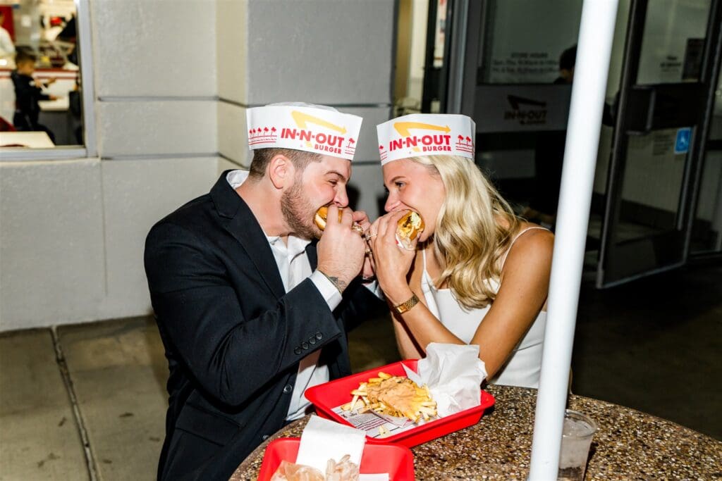 couple celebrating their elopement with burgers