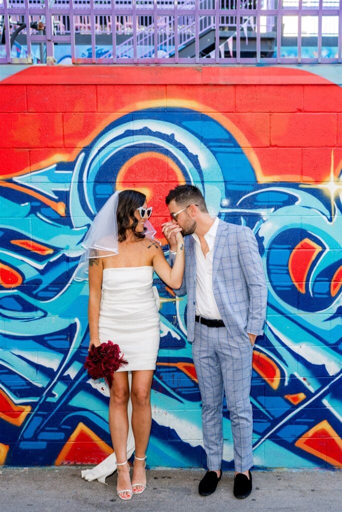 groom kissing the brides hand