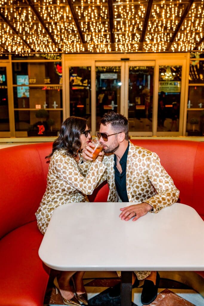 couple celebrating their elopement with drinks