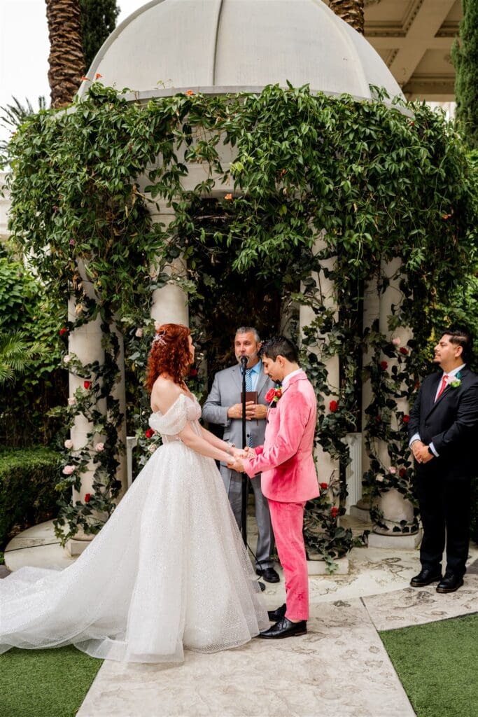 picture of the bride and groom holding hands during their wedding ceremony