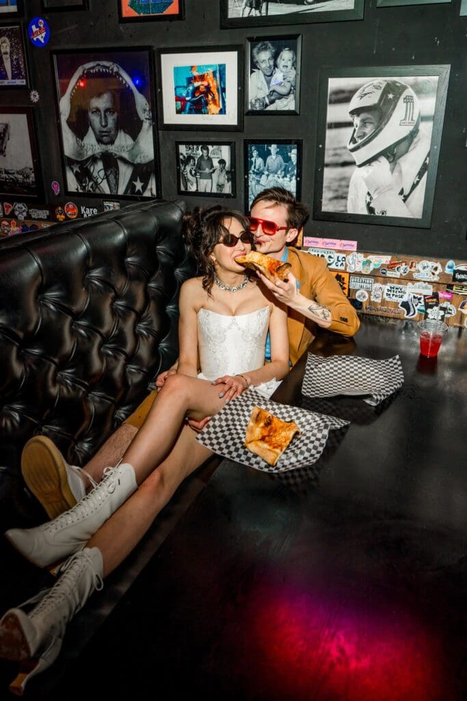 cute picture of the newlyweds celebrating their elopement with pizza