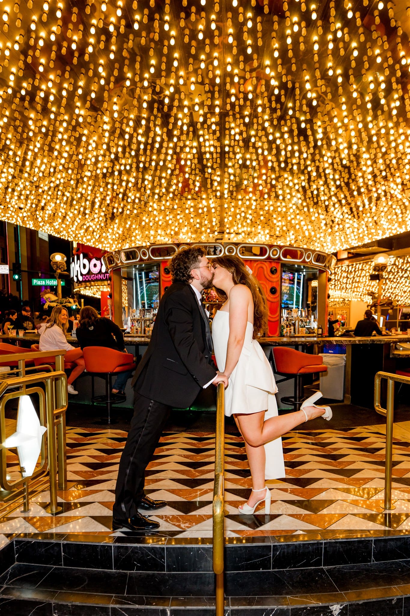 Portrait of the bride and groom, kissing at carousel bar
