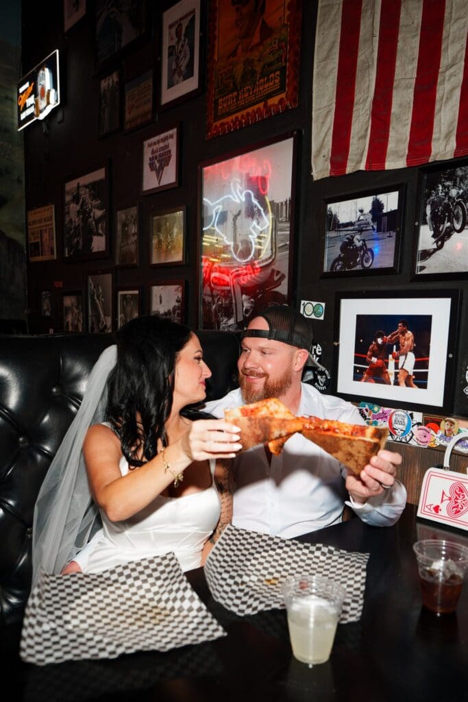 couple celebrating their elopement with pizza