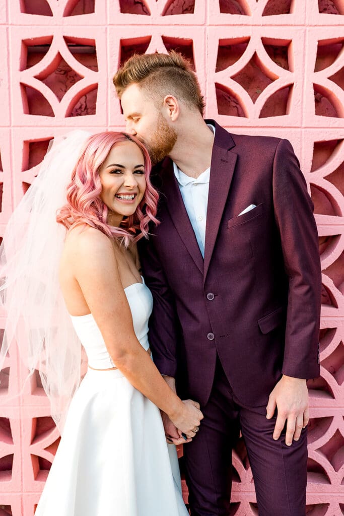 groom kissing the bride on the forehead