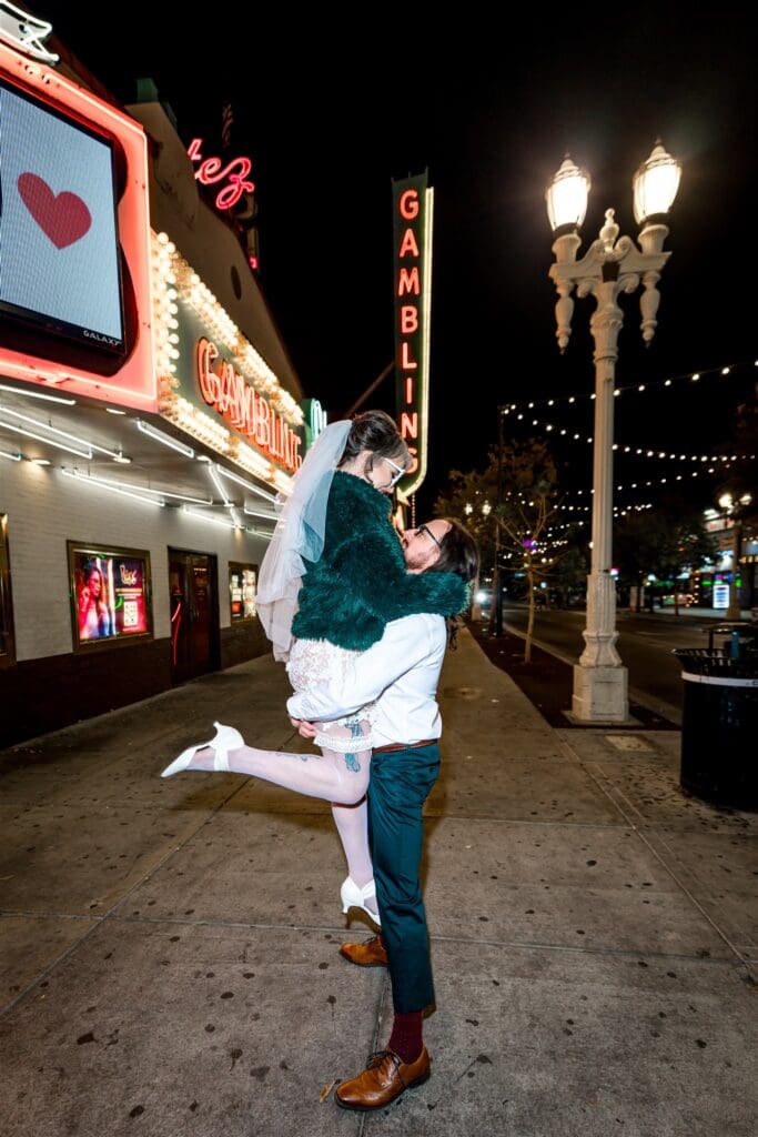 Newly married couple smiling at each other during their photoshoot in Fremont Street