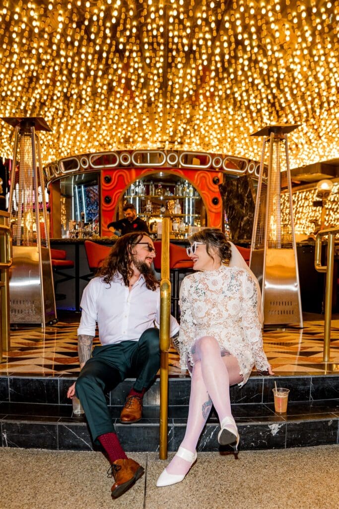 Newly married couple smiling at each other during their photoshoot